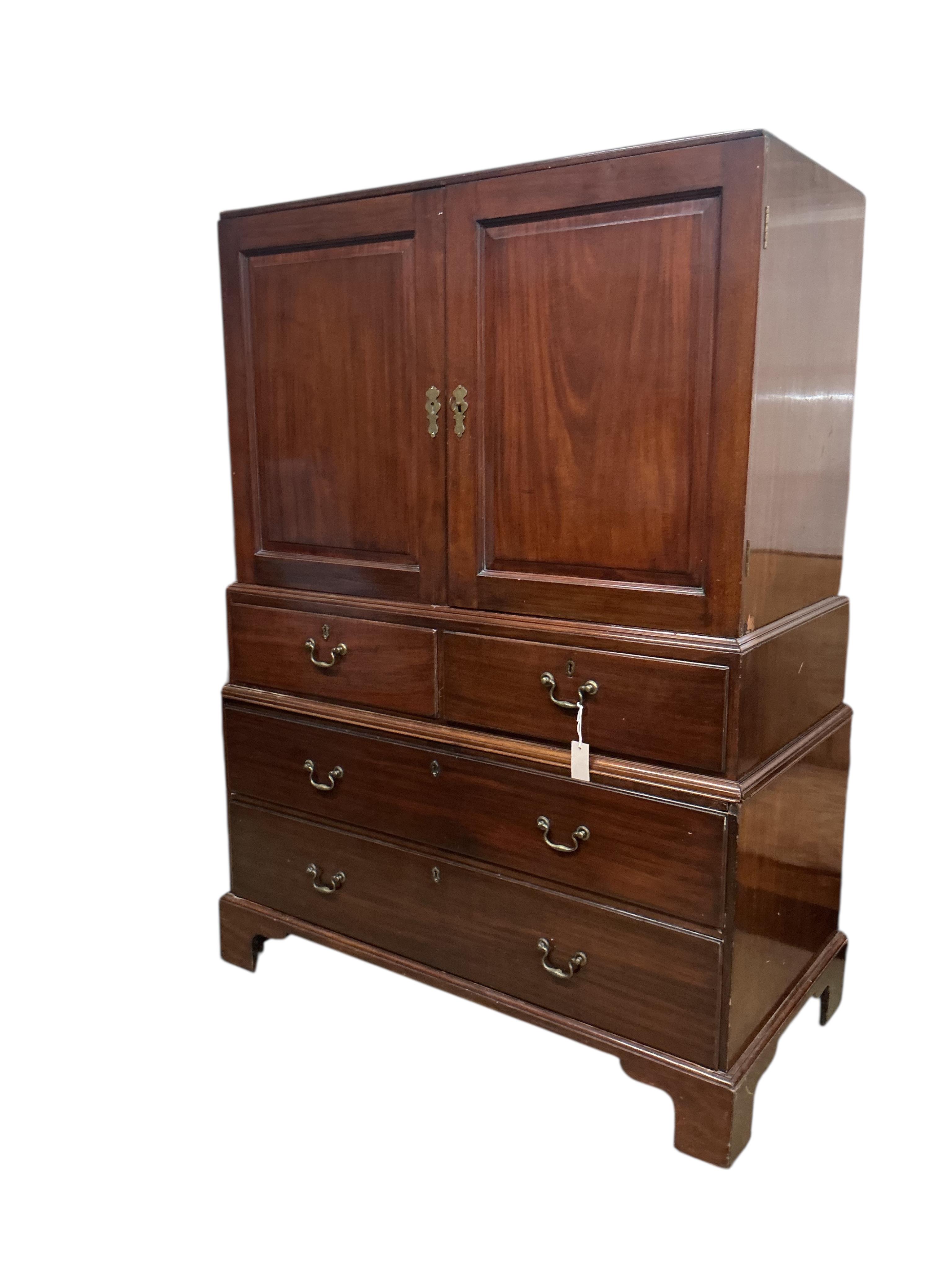 A George II mahogany three part linen press, width 122cm, depth 62cm, height 166cm